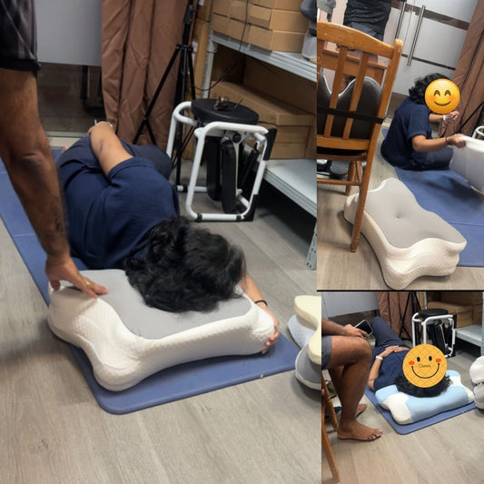 A customer testing the JC Health 17cm ultra high butterfly pillow on a mat at the Singapore Waterloo Street experience center, adjusting the 3-layer memory foam layers for neck support.