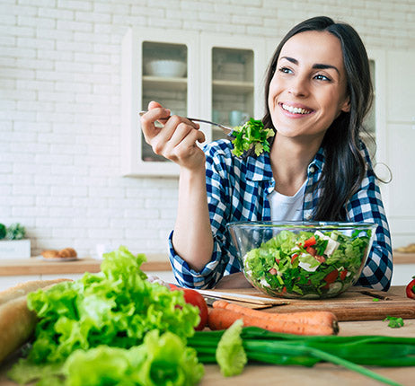 Healthy person eating salad representing body composition and BMI health concepts