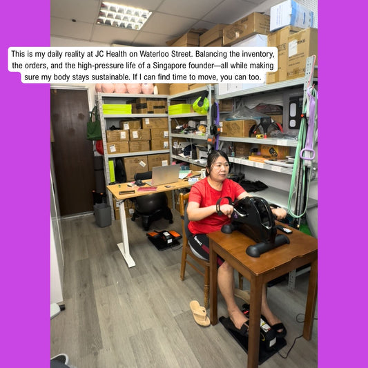 JC Health Founder working at Waterloo Street Singapore store using a mini under-desk elliptical to stay active and build a sustainable life.