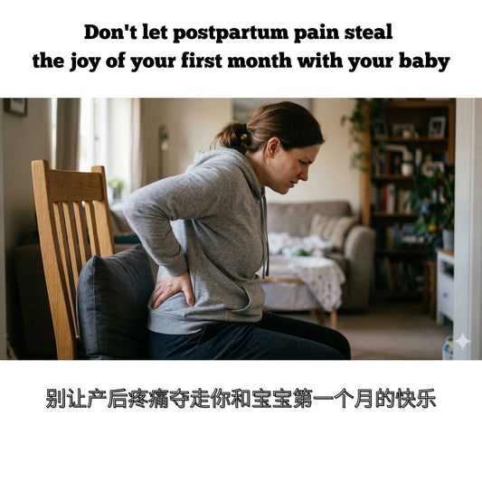 A woman sitting in pain at home after childbirth, touching her lower back and tailbone area, struggling to find comfort on a standard chair with soft pillows