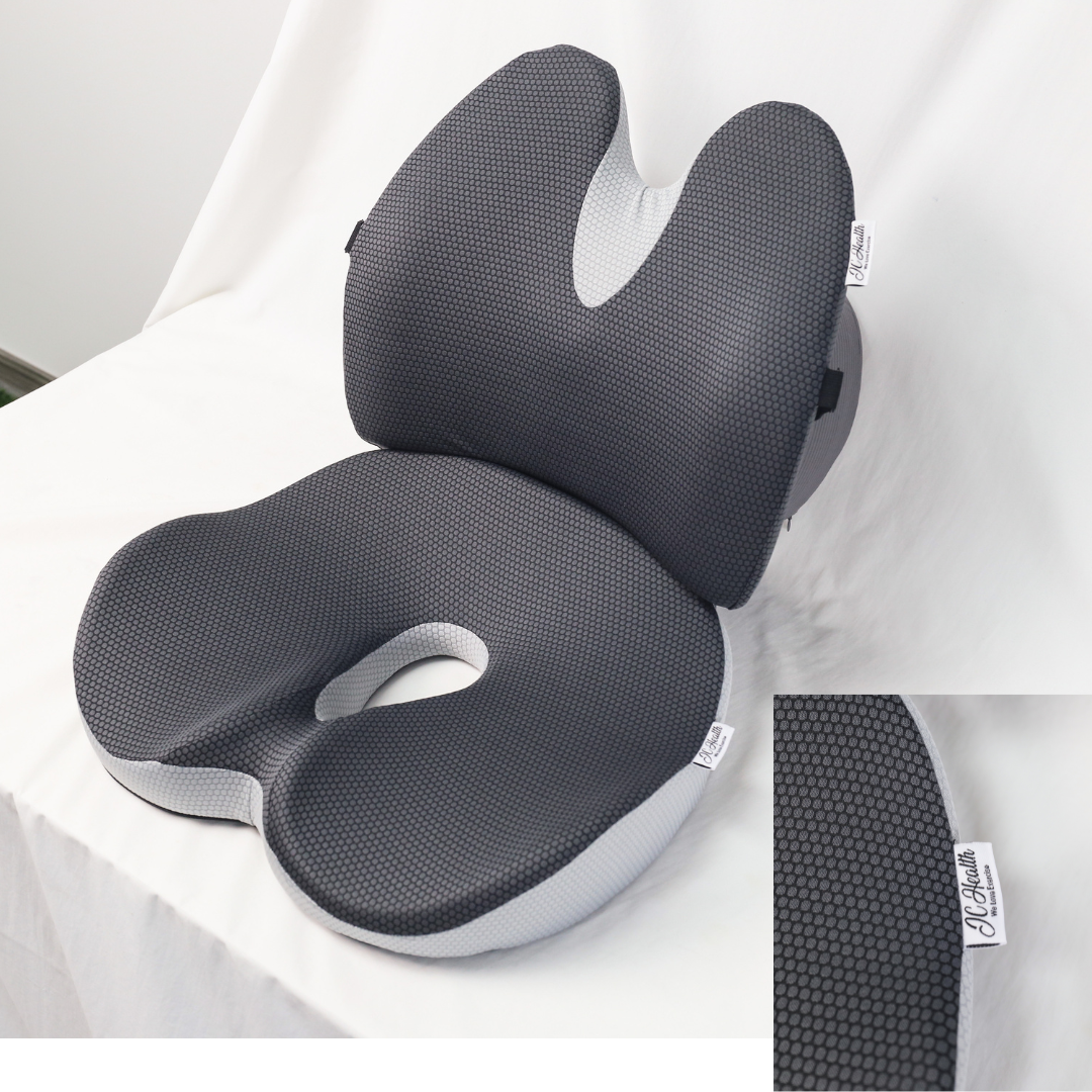 Three-quarter angle of the Integrate Lumbar and Seat Cushion, showing the depth of the coccyx cutout, lumbar wings, and confirming the JC Health brand tag.