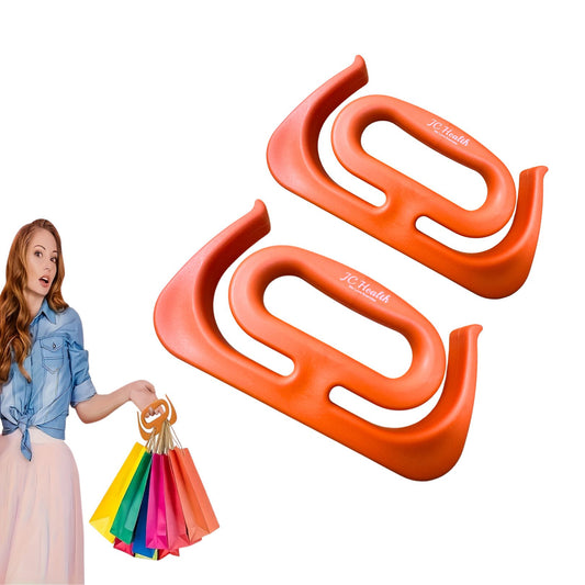 Two orange J.C. Health HandCarry Handles, ergonomic shopping bag carriers designed to reduce hand strain and effort when carrying groceries. A woman in the background holds colorful shopping bags with one handle, demonstrating its use for easy, independent shopping.