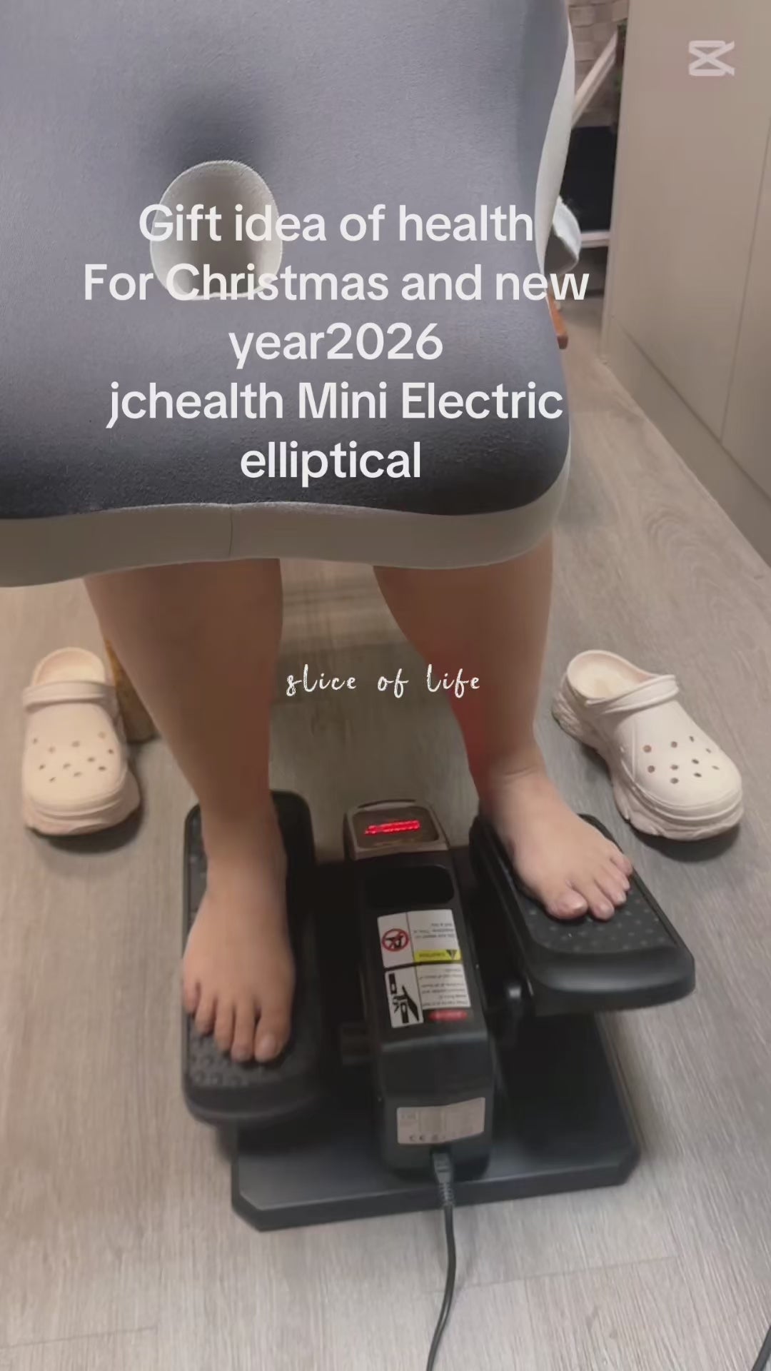 Female office worker testing JC Health electric elliptical trainer at desk, demonstrating quiet operation for workplace fitness and under-desk leg exercise