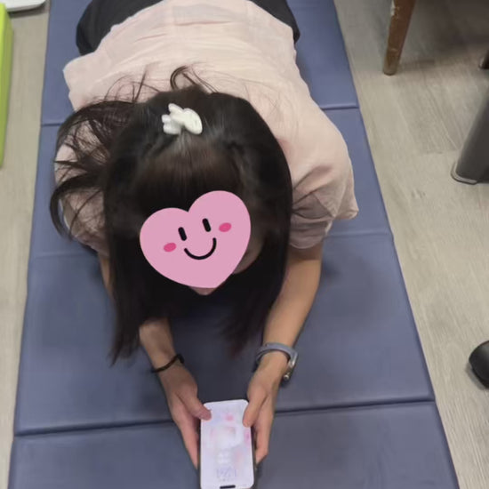 Real customer review demonstrating the JC Health 4-in-1 lounge wedge for prone phone reading. Video shows a young girl comfortably browsing her phone on her stomach with zero chest pressure, highlighting the ergonomic breast support and perfect viewing height of the memory foam cushion