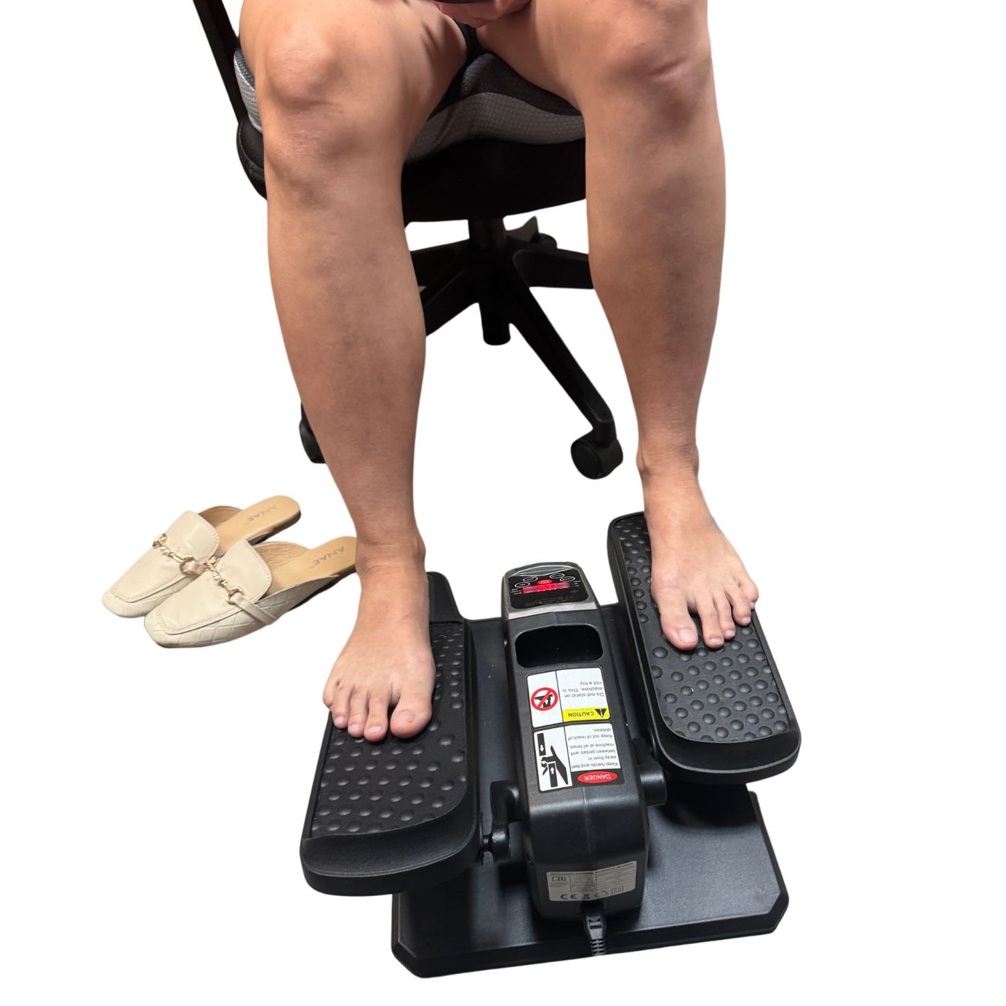 Seated Compact Leg Exerciser used barefoot while sitting in an office chair. Ideal low-impact, quiet home fitness solution for improving circulation