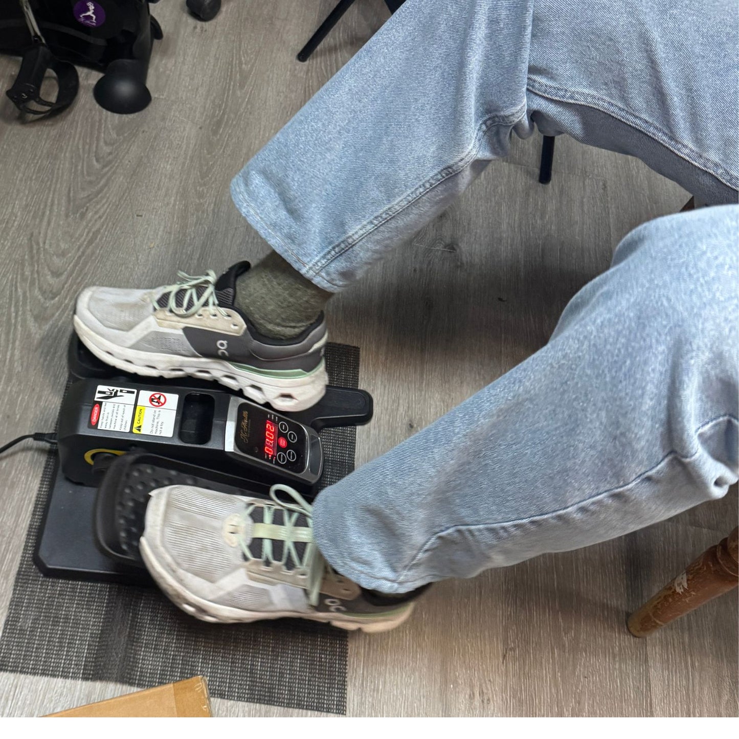 Under Desk Elliptical used with running shoes, close-up on the non-slip foot pedal and digital monitor. Perfect for office or home workout